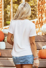 White pumpkin graphic tee with short sleeves and denim skirt