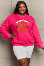 Woman in hot pink pumpkin spice graphic sweatshirt and white biker shorts