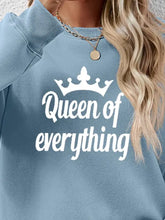 Light blue long-sleeved round neck sweatshirt with white crown and Queen of Everything text