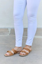 Person in white skinny jeans wearing Qupid Summertime Fine strap twist sandals