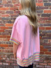 Pink ribbed knit oversized top with rainbow trim cuffs and hem featuring side slits for casual wear