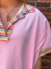 A soft pink ribbed knit polo with a rainbow trim collar and sleeve cuffs from the Rainbow Trim Side Slit Top collection