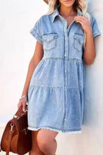 Light blue raw hem button down denim mini dress with short sleeves and frayed hem detailing