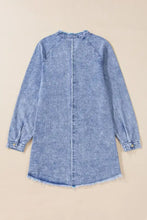 A light blue long sleeve denim dress with raw hem, frayed cuffs, and a subtle faded wash