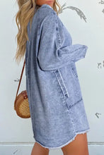 Light-wash long sleeve denim dress with raw hem, frayed cuffs, relaxed fit, and classic patch pockets