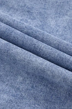 Light-wash raw hem long sleeve denim dress with soft faded blue hue and classic twill weave fabric texture