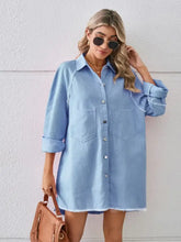 Light blue denim dress with raw hem button front closure and two front pockets in a raw hem button style