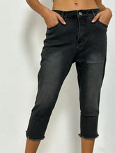 Black denim raw hem capris jeans featuring a frayed hem for a casual stylish look