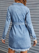 Light-wash denim dress with raw hem collared neck, frayed cuffs, belted waist, and long sleeves