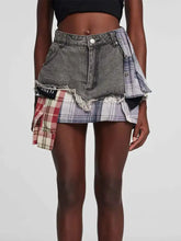 Raw hem denim mini skirt with distressed gray waistband and red and blue plaid patch details