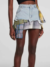 Raw hem denim mini skirt with plaid patch details in yellow green and purple featuring a distressed hem