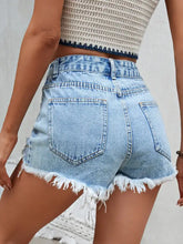 Light wash distressed raw hem denim shorts with high waist