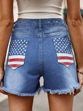 Raw hem denim shorts with American flag pockets and frayed hems
