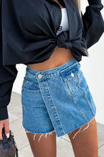 Raw hem denim skorts with light-wash fabric and asymmetric wrap front