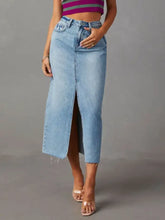 Light-wash raw hem denim midi skirt with front slit and frayed hem perfect for casual styling