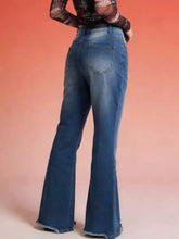 Raw hem high-waisted flare jeans in blue denim with faded wash and frayed hems for a stylish look