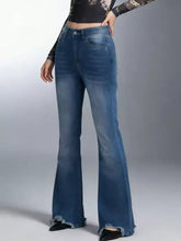 Raw hem high-waisted flare jeans in blue denim featuring frayed hems for a stylish vintage look