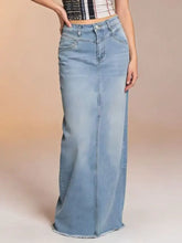 Light-wash denim skirt with raw hem featuring a maxi length and straight-leg cut in a maxi denim skirt style