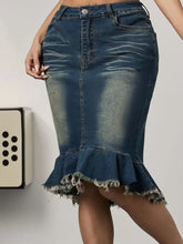 A dark blue raw hem mermaid denim skirt with subtle fading and a flared frayed hem