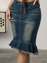 Dark blue raw hem mermaid denim skirt with frayed ruffled hem and subtle fading for a distressed look