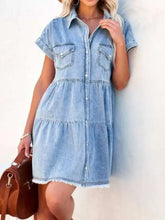 Light-wash denim dress with raw hem short sleeves button-front closure and two chest pockets