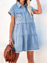 Light blue raw hem short sleeve denim dress with button front and tiered ruffles in lightweight denim fabric