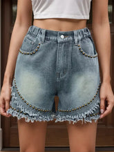 Raw hem studded denim shorts with frayed edges and metallic details