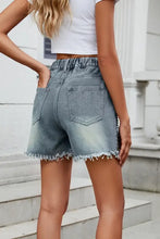 Light wash distressed raw hem studded denim shorts with elastic waist
