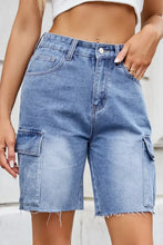 Light wash blue denim cargo shorts with raw hem and pockets