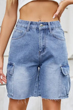 Light wash raw hem washed denim shorts with cargo pockets