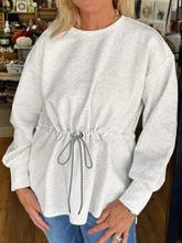 A heather gray rawstring waist tunic solid sweatshirt with a relaxed fit, slightly stretchy fabric, machine wash and tumble dry