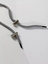 Black and white striped rope shoelaces with metallic silver aglets on slightly stretchy rawstring waist tunic solid sweatshirt