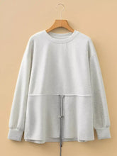 Light gray rawstring waist tunic solid sweatshirt with drawstring waist and ribbed cuffs made of slightly stretchy fabric with machine wash care instructions