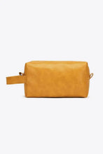 Rectangular leather makeup bag in mustard yellow with side handle