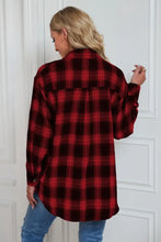 Oversized red and black plaid flannel shirt with button-down closure and sleeve length