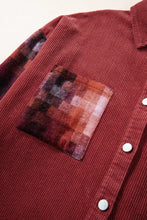 Red corduroy shirt jacket with plaid pocket patch and white buttons