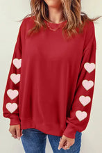Red heart round neck dropped shoulder sweatshirt with pink heart patches