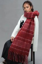 Woman modeling red plaid thermal scarf with fringe and white knit sweater
