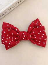 Red polka dot bow hair accessory for long wavy brown hair