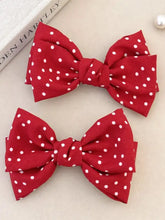 Red polka dot bow hair accessory for long wavy brown hair
