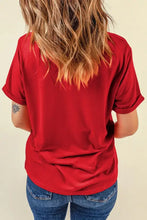 Red v-neck t-shirt with star sequin design, rolled sleeves and jeans