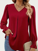 Wine-colored v-neck blouse with flounce sleeves and shirred cuffs