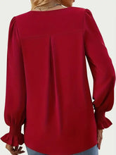 Red V-neck blouse with flounce sleeves and shirred cuffs