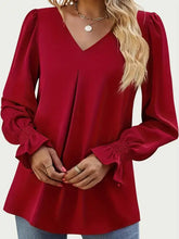 Red V-neck blouse with flounce sleeves and shirred cuffs