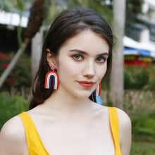 Woman in red white blue geometric dangle earrings with stainless steel beads