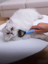 Blue and black stainless steel pet hair removal comb with ergonomic handle reduces shedding