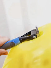 Blue gray-handled stainless steel pet hair removal rake on yellow fur