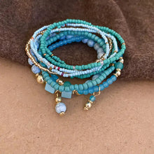 Resin rice bead bracelet with blue turquoise beads and gold charms