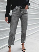 Grey denim rhinestone embellished cropped jeans with a straight-leg cut and sparkling rhinestone detailing on cuffs