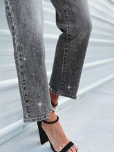 Grey denim rhinestone embellished cropped jeans with sparkling rhinestones along legs and frayed hems